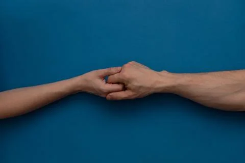 Middle finger gesture on a blue background Stock Photos