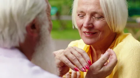In the middle of park at the cafe beautiful old woman in love spending romantic Stock Footage 164765221