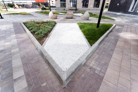 In the middle of the park, there is a triangular feature surrounded by gree.. Stock Photos