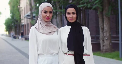 Middle plan shot of two young Arabic beautiful women in traditional headscarves Stock Footage 139629503
