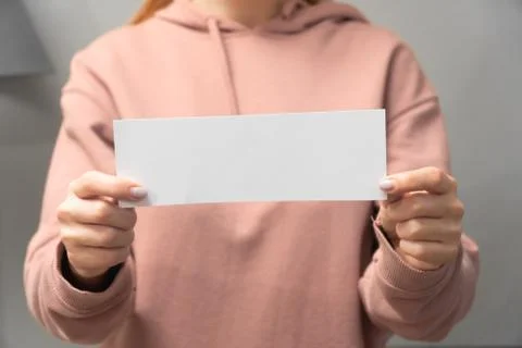 Middle plan womans hand holds white paper for text inscription.the concept sp Stock Photos