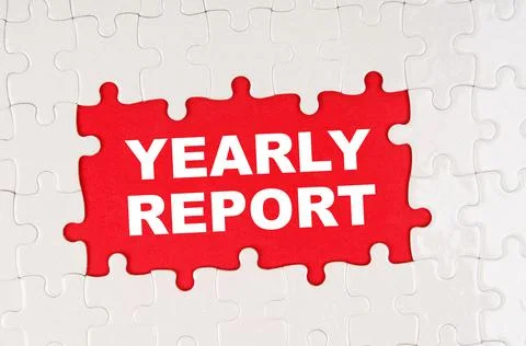 In the middle of the puzzles on a red background it is written - YEARLY REPOR Stock Photos