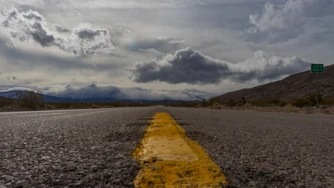 Middle of the Road Low angle Black, White and Yellow Mt. Charleston Time Laps Stock Footage 128943901