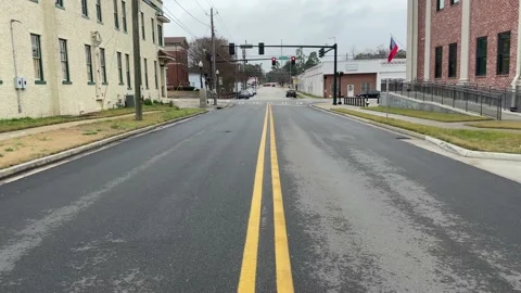 Middle of the road view of traffic downtown Waynesboro Georgia Stock Footage 148967956