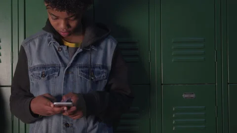 Middle School Boy Scrolling on a Cellphone Video stock 208740700