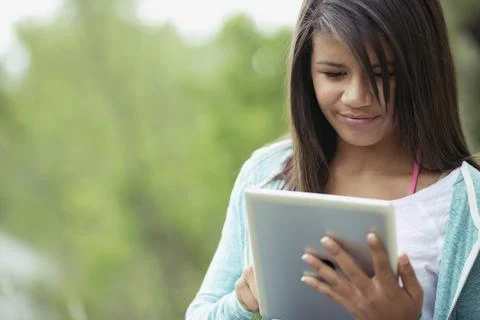Middle school student using pc tablet outdoors Stock Photos