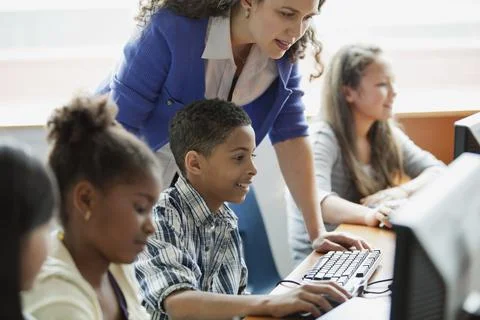 Middle school students learning in computer lab Stock Photos