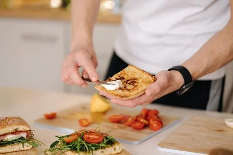 Middle selection of man spread cream cheese on baguette. Home made sandwich Stock Photos
