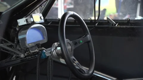 Middle shot of pilot seat inside the real drag racing car with steering wheel Stock Footage 220494150