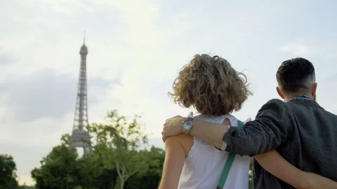 Middleaged couple on a romantic date walk arm in arm toward the Eiffel Tower. Stock Footage 115629396