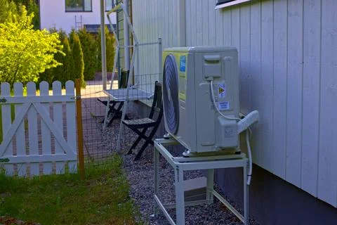 Midea air source heat pump unit installed outside a residential house in Tu.. Stock Photos