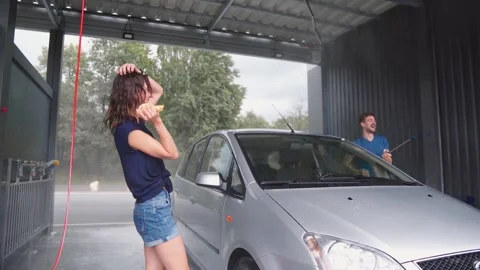 Midframe Woman Eats Sandwich Beside Car While Man Watches Stock Footage 340920899