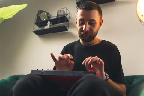 MIDI controller keyboard used by a middle-aged bearded caucasian creator guy Stock Photos