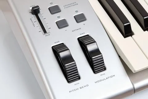 Midi keyboard controller close up with faders wheel buttons and knobs pitch, Stock Photos