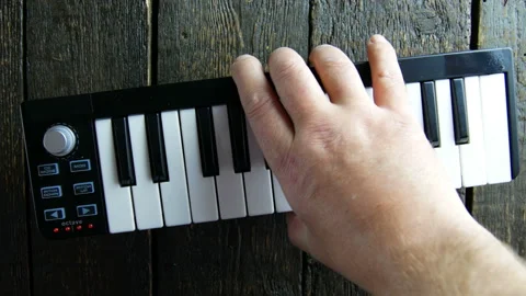 Midi keyboard on wooden background Stock Footage 106937906