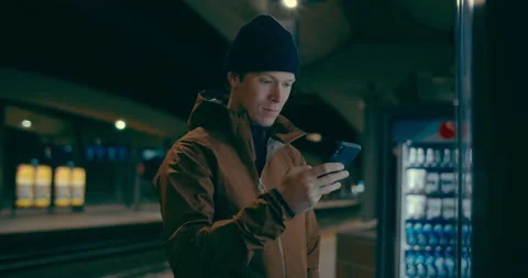 Midnight commuter wait for train on dark platform Stock Footage 144403325