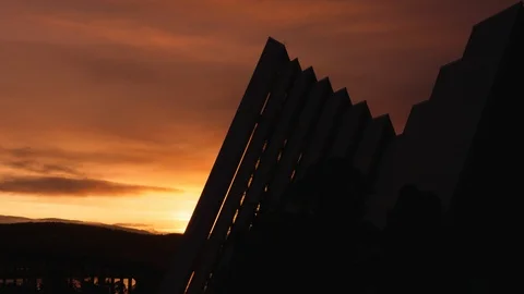 Midnight sun behind Tromso Arctic Cathedral Time lapse of orange sky clouds. Stock-Footage 113733759