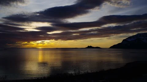 Midnight sun time-lapse in tranquil Arctic Norway cloudy sky and ocean Stock Footage 148548427
