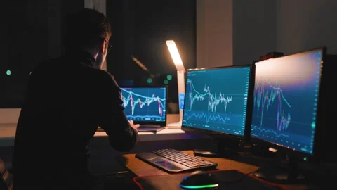 Midnight Trading Close-Up of Young Man Analyzing Charts on Computer Monitor Stock Footage 232412054