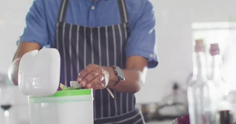 Midsection of african american man composting waste in kitchen Vídeo Stock 341936559
