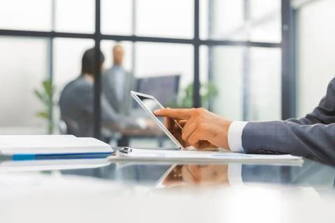 Midsection of businessman using digital tablet in office. Foto stock