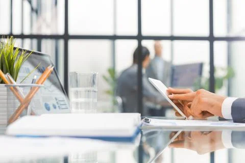 Midsection of businessman using digital tablet in office. Stock Photos