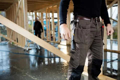 Midsection Of Carpenter Standing At Site Stock Photos