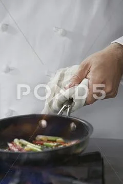 Midsection Of Chef Cooking Food Stock Photos
