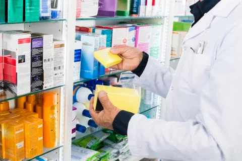 Midsection Of Chemist Holding Medicine Boxes 写真素材