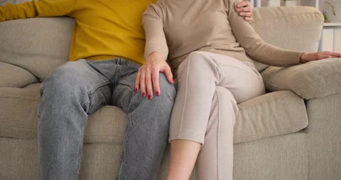 Midsection of couple romancing on sofa Stock Footage 145216341