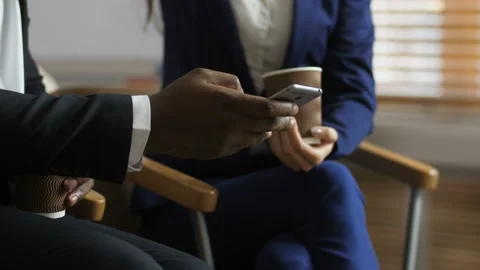 Midsection of diverse colleagues looking at phone Stock Footage 108011722
