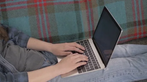Midsection Of Female Blogger Using Laptop On Sofa At Home Stock Footage 79657615