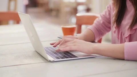 Midsection of female blogger using laptop at table in cafe Stock Footage 79659394