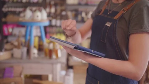 Midsection Of Female Deli Owner Using Tablet Computer In Delicatessen Stock-Footage 79657926