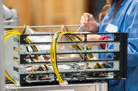 Midsection of female engineer repairing computer part in electronics industry Stock Photos