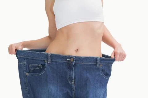 Midsection of female wearing old pants after losing weight Stock Photos