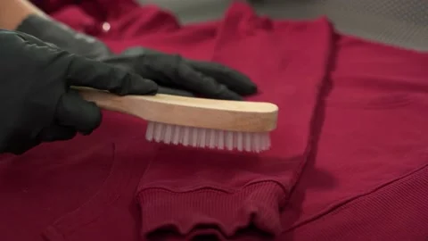 Midsection of female worker standing at workplace with professional dry cleaning Stock Footage 152963300