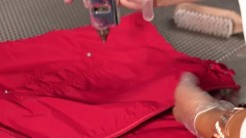 Midsection of female worker standing at workplace with professional dry cleaning Stock Footage 152963496