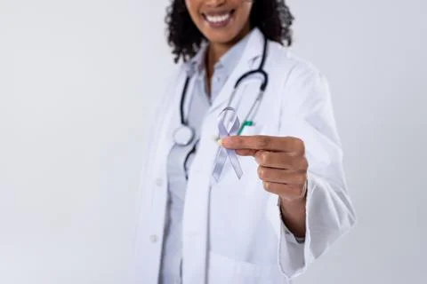 Midsection of happy african american mid adult female doctor with white lung Stock Photos
