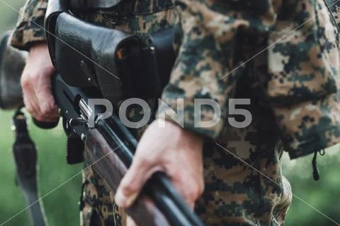 Midsection of hunter holding rifle Stock Photos