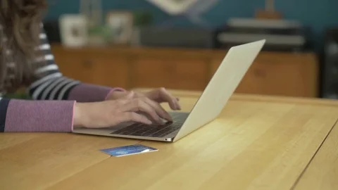 Midsection Lockdown Shot Of Woman Using Laptop And Credit Card Stock Footage 79656757