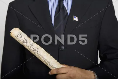 Midsection of a man holding a copy of the US Constitution Stock Photos