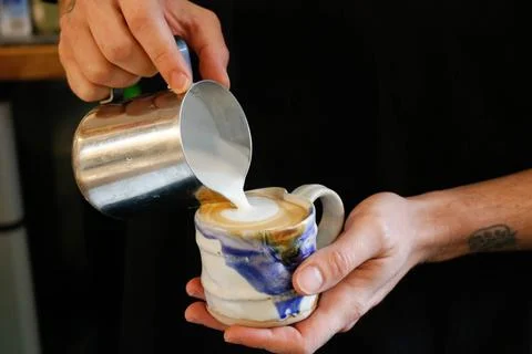 Midsection of man making coffee in cafe Stock Photos