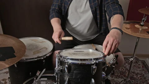 Midsection of Man Tuning Drum Head with Key in Music Rehearsal Studio Stock Footage 347120684