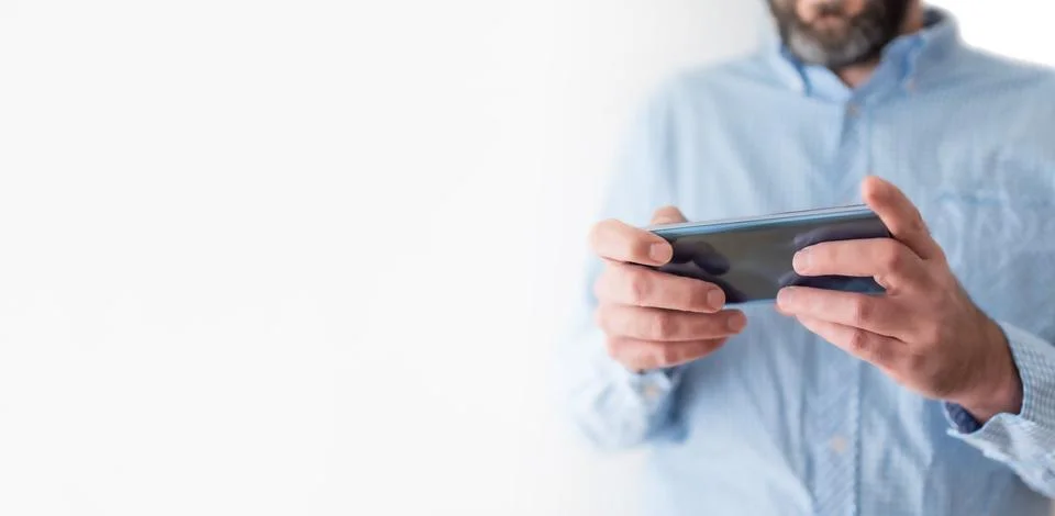 Midsection of man using mobile phone or smartphone Stock Photos
