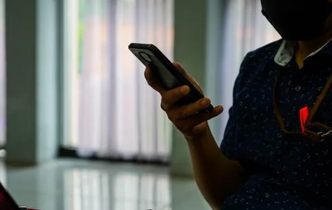 Midsection Of Man Using Mobile Phone At the office Stock Photos