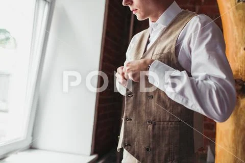 Midsection of mature businessman buttoning his vest Stock Photos