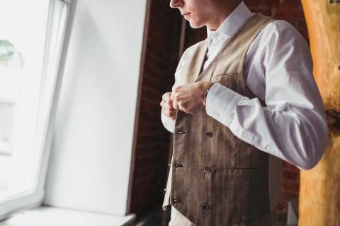 Midsection of mature businessman buttoning his vest Stock Photos