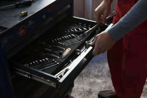Midsection of mechanic removing tools from drawer at garage 스톡 사진