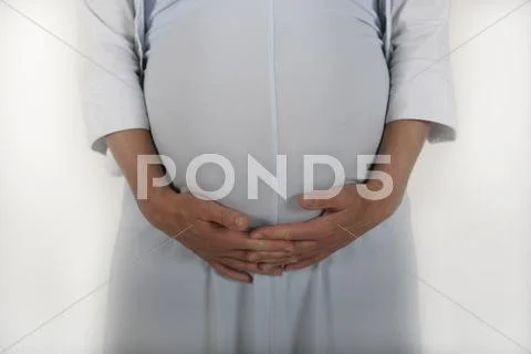 Midsection of a pregnant woman holding her stomach Stock Photos